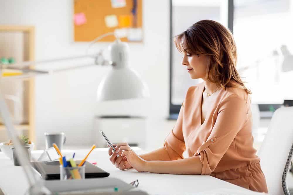 businesswoman with smartphone working at office