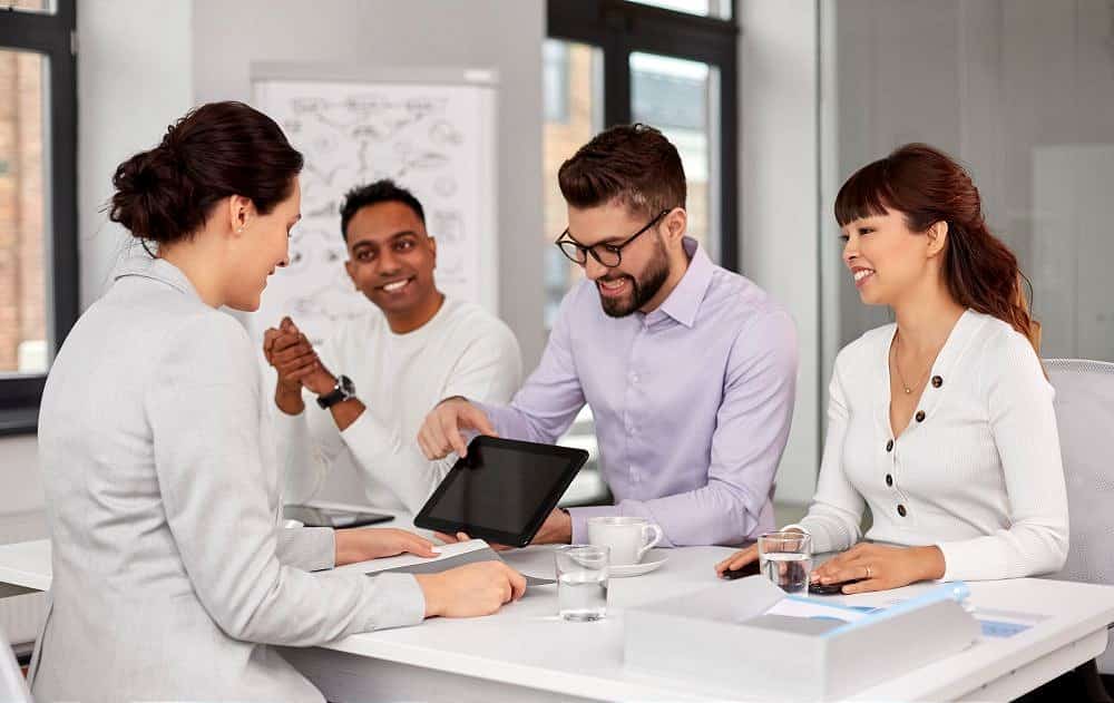 team of recruiters with tablet pc at job interview