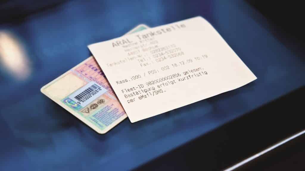 Tankstellenquittung liegt auf Führerschein